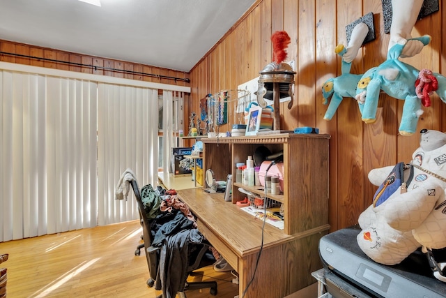 home office featuring hardwood / wood-style floors and wooden walls