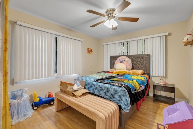 bedroom with light wood-type flooring and ceiling fan