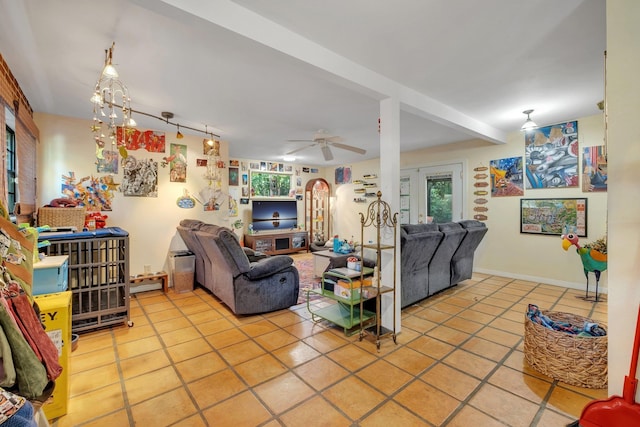 tiled living room featuring ceiling fan and rail lighting