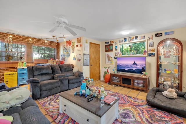 living room with brick wall, ceiling fan, and light tile patterned flooring