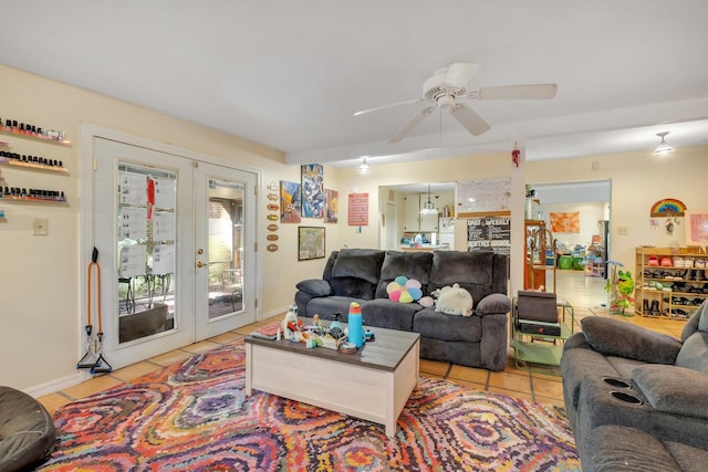 living room with french doors, ceiling fan, and light tile patterned floors