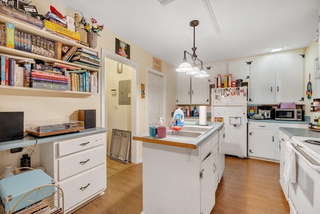 kitchen featuring white cabinetry, light hardwood / wood-style floors, hanging light fixtures, and white appliances