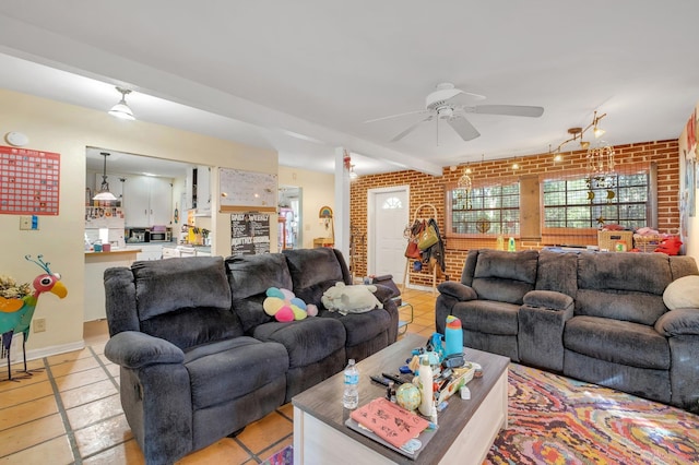 living room featuring light tile patterned flooring, ceiling fan, and brick wall