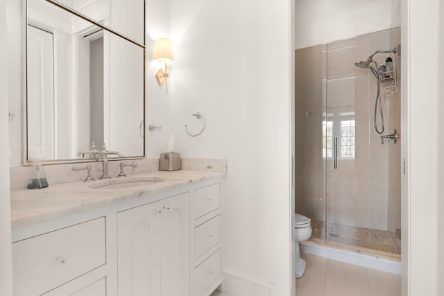 bathroom with toilet, vanity, tile patterned floors, and a shower with door