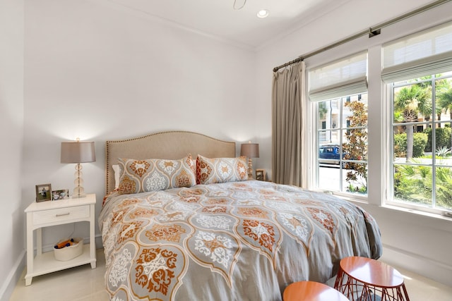 bedroom featuring multiple windows and crown molding