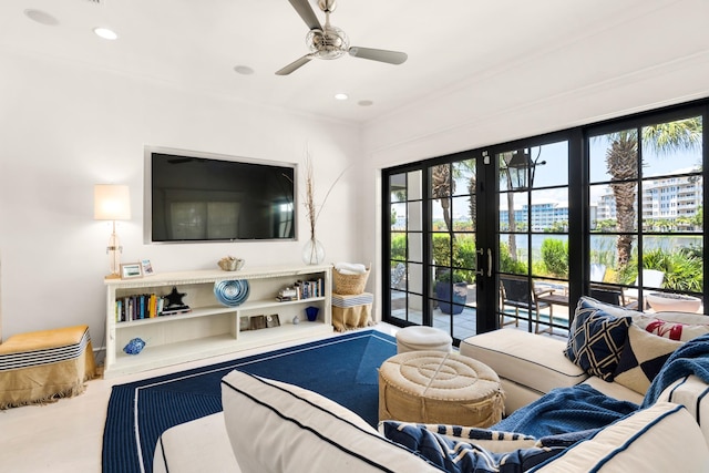 carpeted living room featuring french doors and ceiling fan