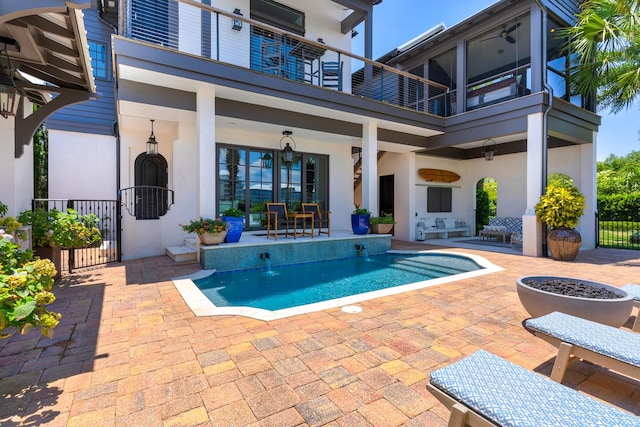 view of pool featuring ceiling fan, a patio, and an outdoor living space