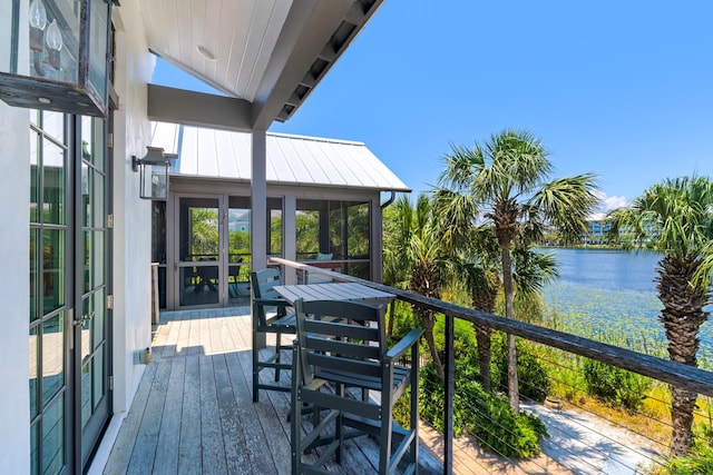 deck featuring a sunroom and a water view