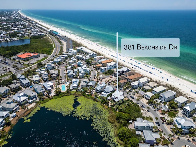 bird's eye view featuring a water view and a beach view