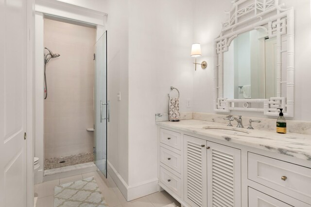 bathroom with tile patterned flooring, vanity, and an enclosed shower