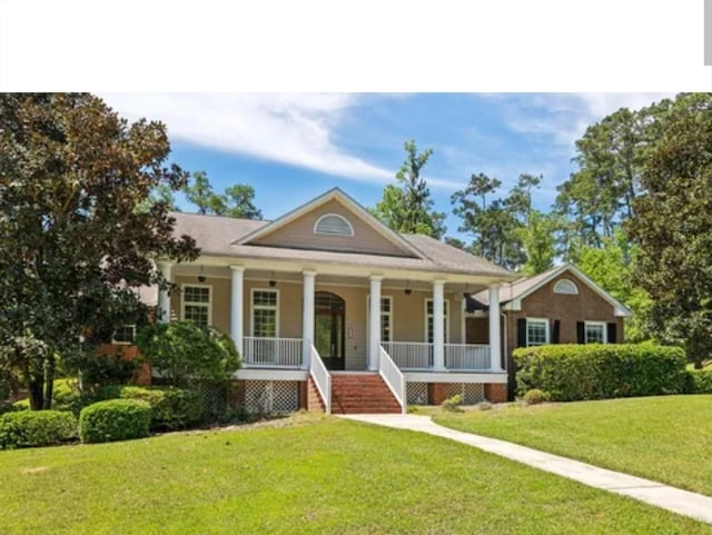 view of front facade with a front lawn and a porch