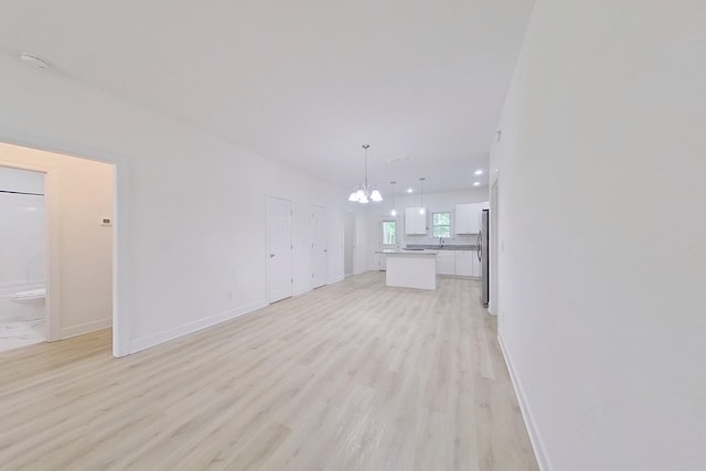 103 Heather Ln, Thomasville, GA 31792 - unfurnished living room with a chandelier, light wood-type flooring, baseboards, and recessed lighting
