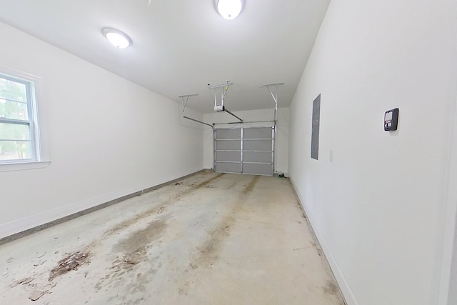103 Heather Ln, Thomasville, GA 31792 - garage with a garage door opener, baseboards, and electric panel