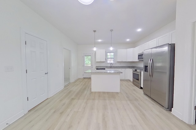 103 Heather Ln, Thomasville, GA 31792 - kitchen featuring appliances with stainless steel finishes, light wood-style floors, a center island, white cabinets, and recessed lighting