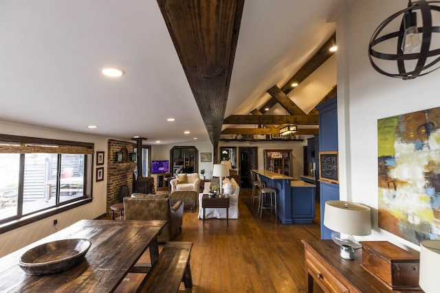 dining room featuring dark wood-type flooring, lofted ceiling with beams, and recessed lighting