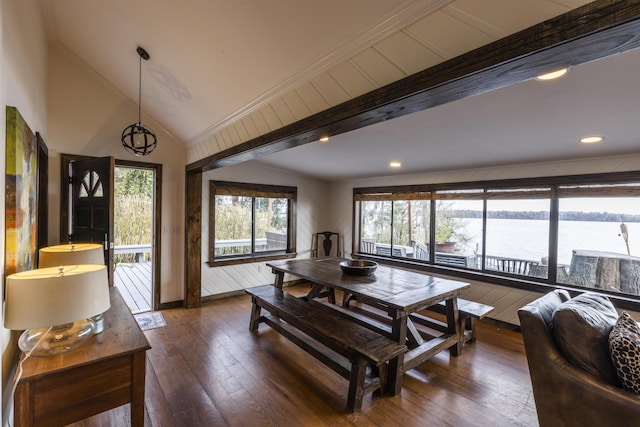 dining room with vaulted ceiling, recessed lighting, dark wood-type flooring, and a water view