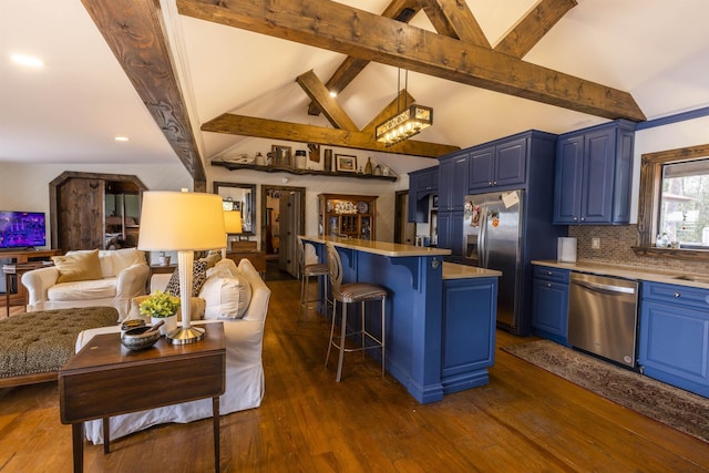 kitchen featuring open floor plan, a breakfast bar area, light countertops, appliances with stainless steel finishes, and blue cabinets