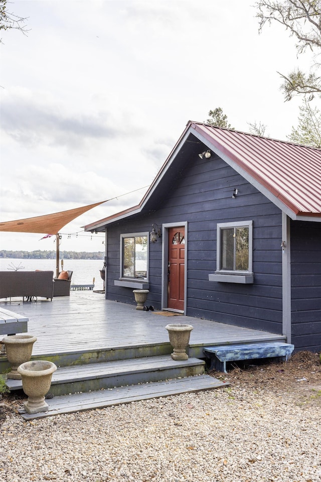 view of front of home with metal roof and a wooden deck