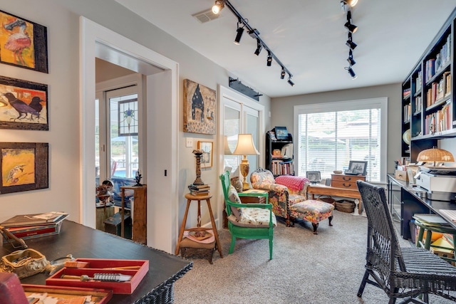office space featuring rail lighting, visible vents, and carpet floors