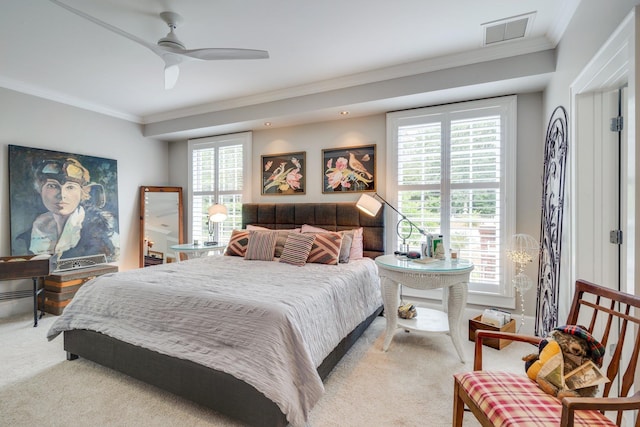 carpeted bedroom with visible vents, a ceiling fan, and ornamental molding