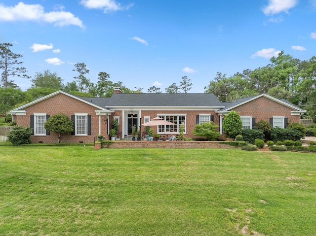 ranch-style home with a chimney, brick siding, a front lawn, and crawl space