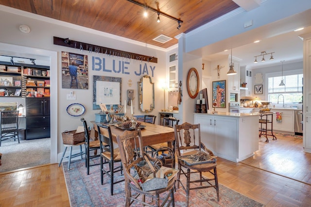 dining space with rail lighting, visible vents, ornamental molding, and wood ceiling