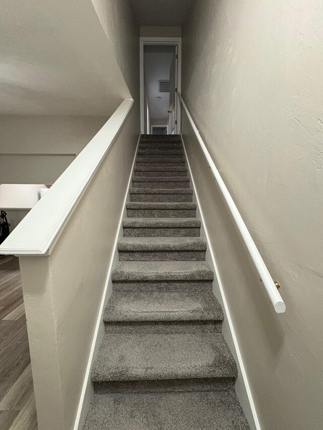 2525 Hartsfield Rd Unit 9, Tallahassee, FL 32303 - staircase featuring wood finished floors