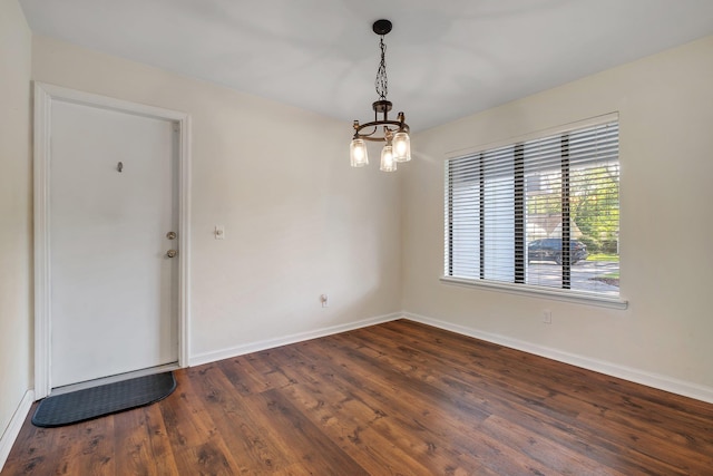 3268 Garcia Dr, Tallahassee, FL 32309 - empty room featuring baseboards, dark wood finished floors, and a chandelier