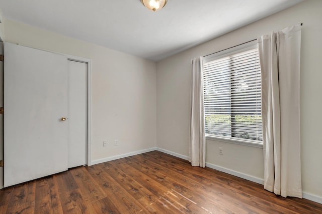 3268 Garcia Dr, Tallahassee, FL 32309 - unfurnished bedroom with multiple windows, hardwood / wood-style flooring, and baseboards