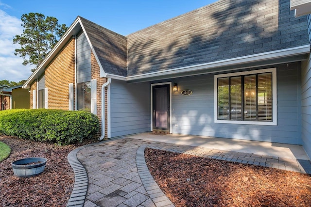3268 Garcia Dr, Tallahassee, FL 32309 - property entrance with roof with shingles and a porch
