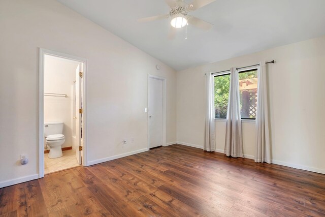 3268 Garcia Dr, Tallahassee, FL 32309 - unfurnished bedroom featuring vaulted ceiling, wood finished floors, baseboards, and connected bathroom
