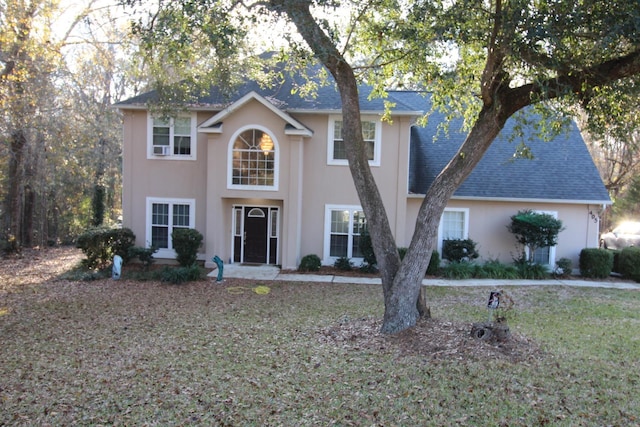 view of property featuring a front lawn