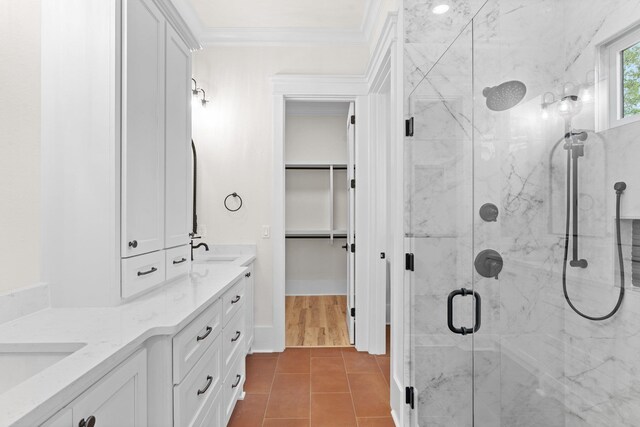 3235 Magazine Cir, Tallahassee, FL 32312 - bathroom with a marble finish shower, crown molding, double vanity, tile patterned floors, and a walk in closet