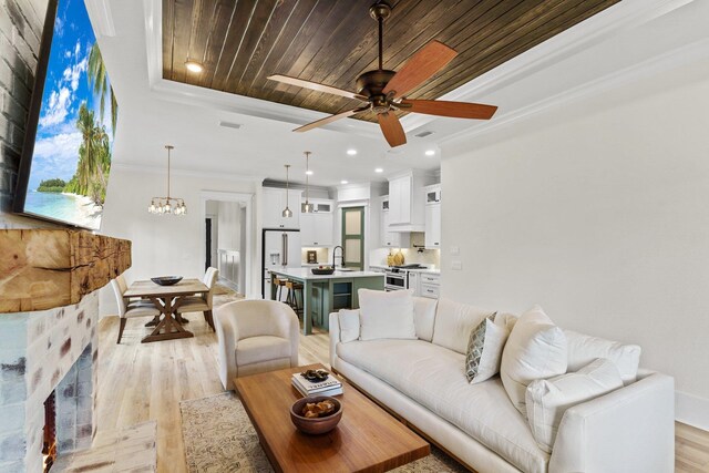 3235 Magazine Cir, Tallahassee, FL 32312 - living room featuring light wood-type flooring, a ceiling fan, a tray ceiling, wooden ceiling, and a chandelier