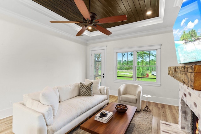 3235 Magazine Cir, Tallahassee, FL 32312 - living area with a raised ceiling, a lit fireplace, crown molding, baseboards, and wood finished floors