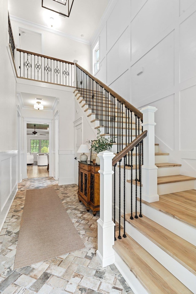 3235 Magazine Cir, Tallahassee, FL 32312 - stairs with a decorative wall, a towering ceiling, and crown molding