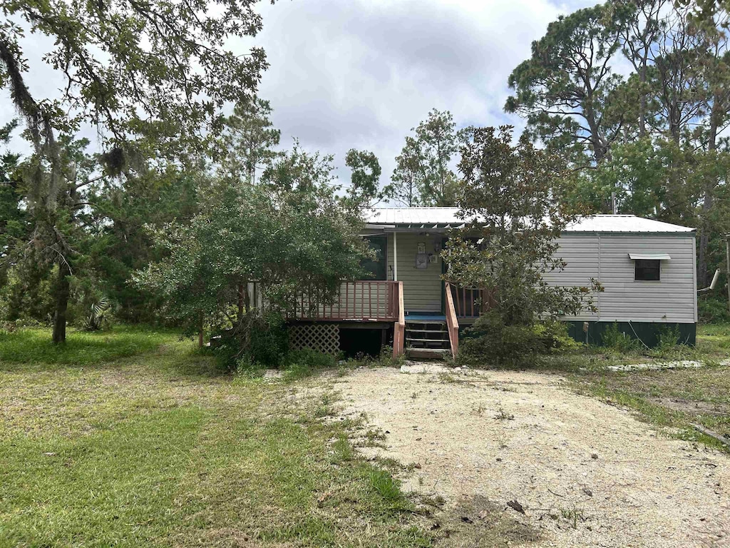 2290 Red Oak Rd, Perry, FL 32348 - view of front of property with a wooden deck and a metal roof