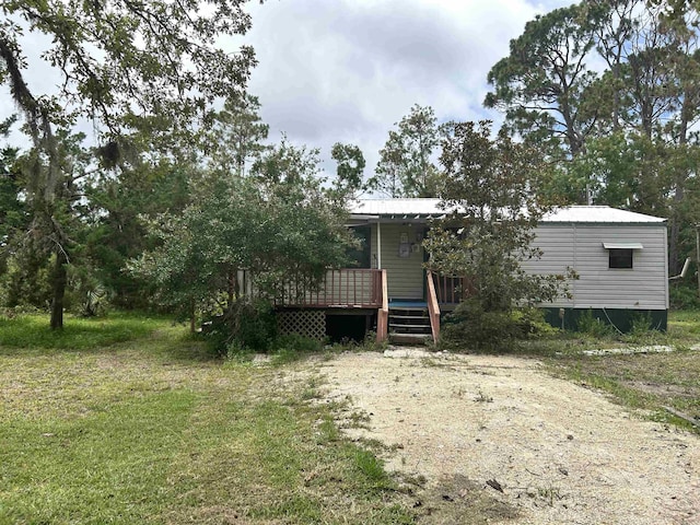 2290 Red Oak Rd, Perry, FL 32348 - view of front of property with a wooden deck and a metal roof