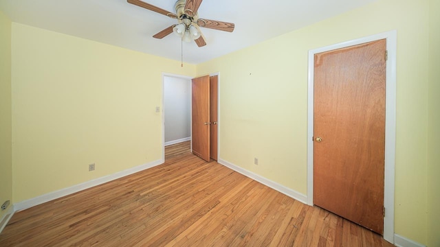 unfurnished bedroom featuring ceiling fan and light hardwood / wood-style flooring