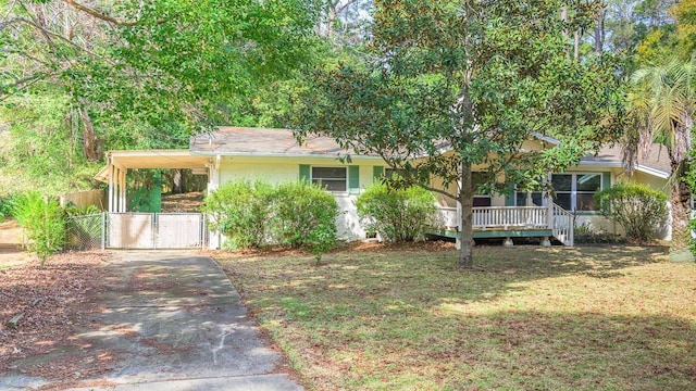 view of front of home with a front yard, a carport, and a porch