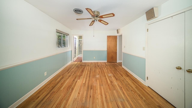 unfurnished bedroom with ceiling fan and light wood-type flooring