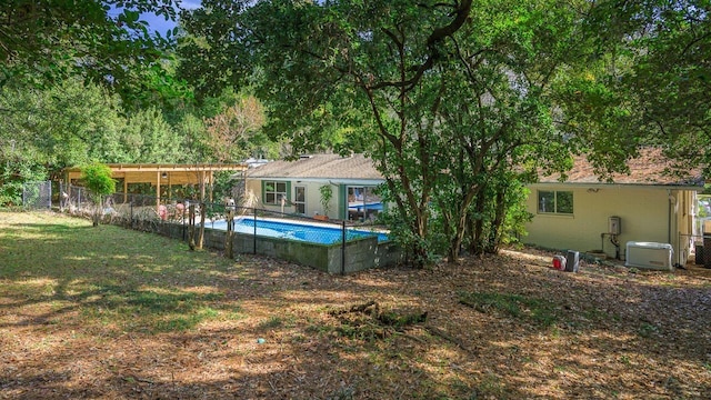 view of yard with a fenced in pool