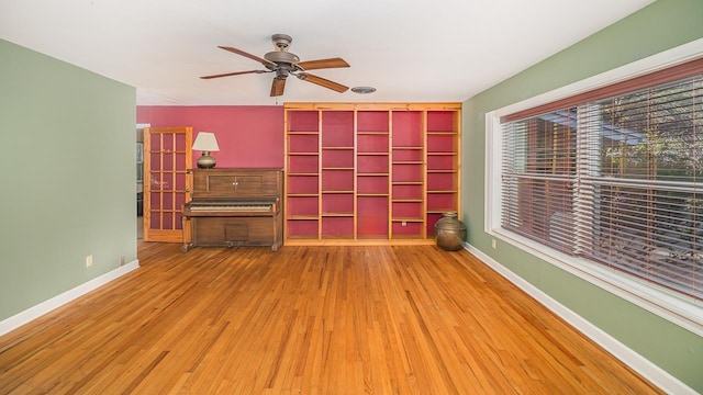 spare room with hardwood / wood-style flooring and ceiling fan