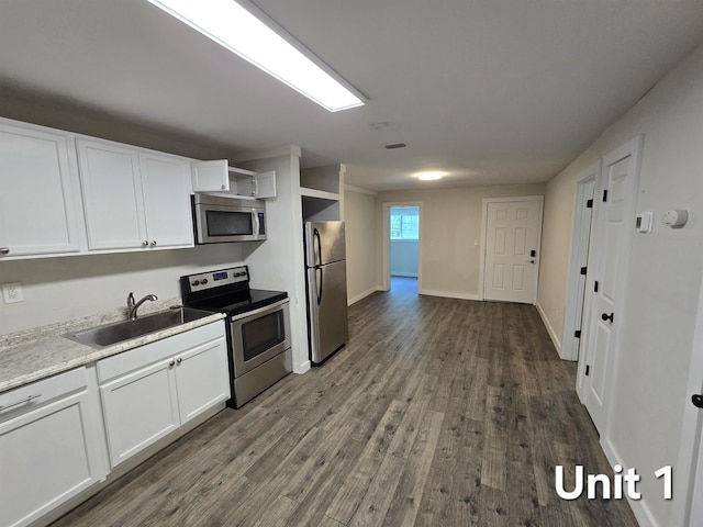 208 Putnam Dr Unit 1, 2, 3, Tallahassee, FL 32301 - kitchen with appliances with stainless steel finishes, dark wood-style flooring, and white cabinetry