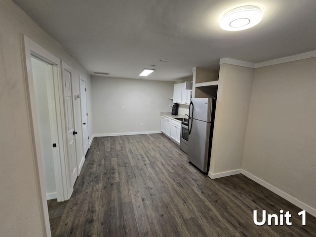 208 Putnam Dr Unit 1, 2, 3, Tallahassee, FL 32301 - kitchen featuring appliances with stainless steel finishes, dark wood-type flooring, white cabinetry, and light countertops
