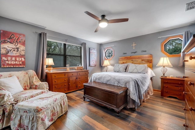 bedroom with dark hardwood / wood-style floors and ceiling fan