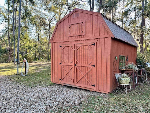 view of outbuilding featuring a lawn