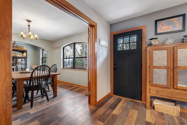 entryway featuring an inviting chandelier and dark wood-type flooring