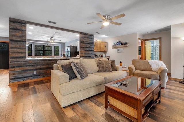 living room with ceiling fan and hardwood / wood-style floors