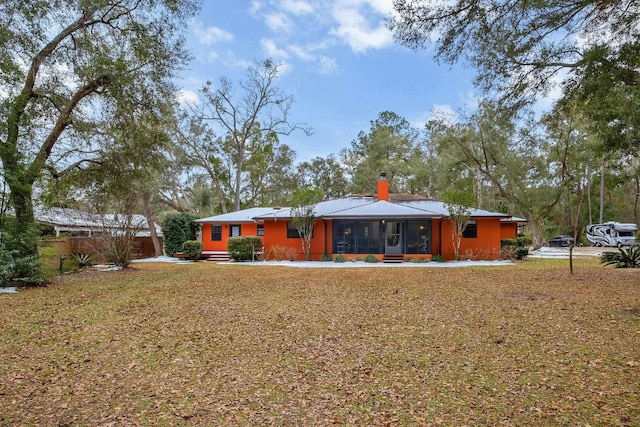 back of house featuring a sunroom